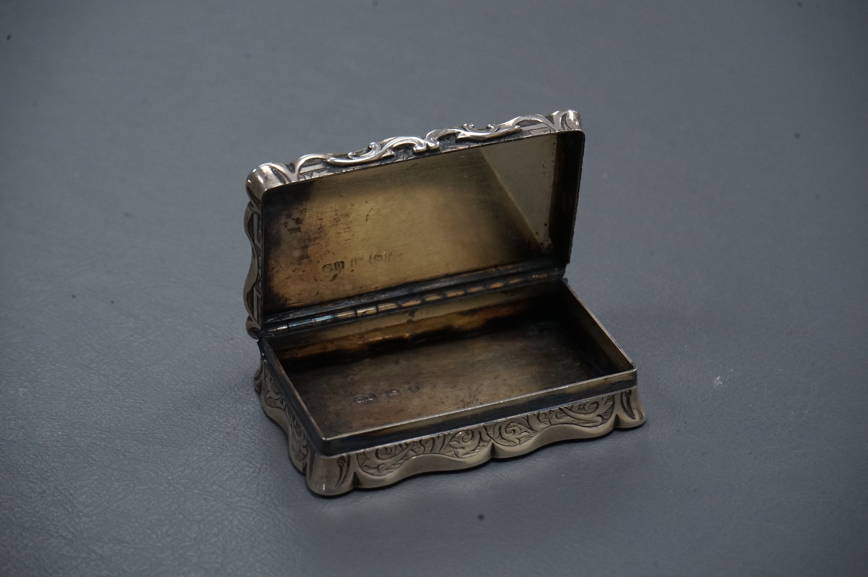 A Victorian engraved silver shaped rectangular snuff box, by George Unite, Birmingham, 1867, 7cm.